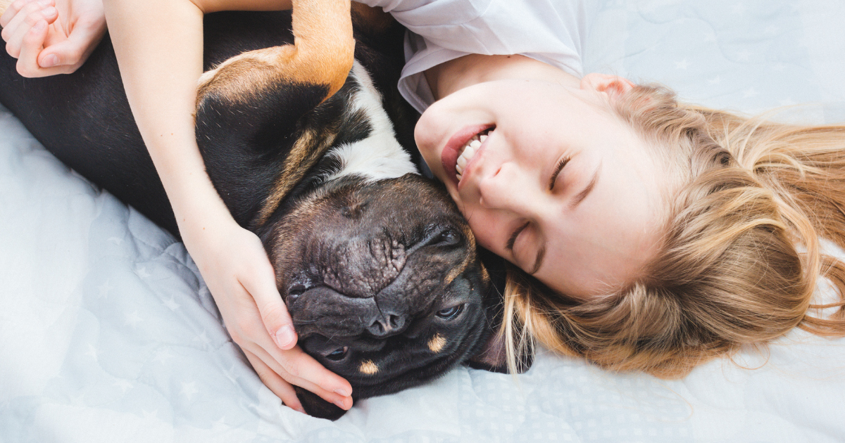 woman and her dog have a cuddle
